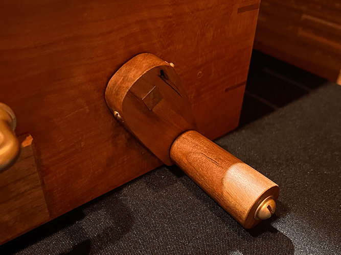 Close-up of the handcrafted wooden crank mechanism that advances the interactive Declaration scroll