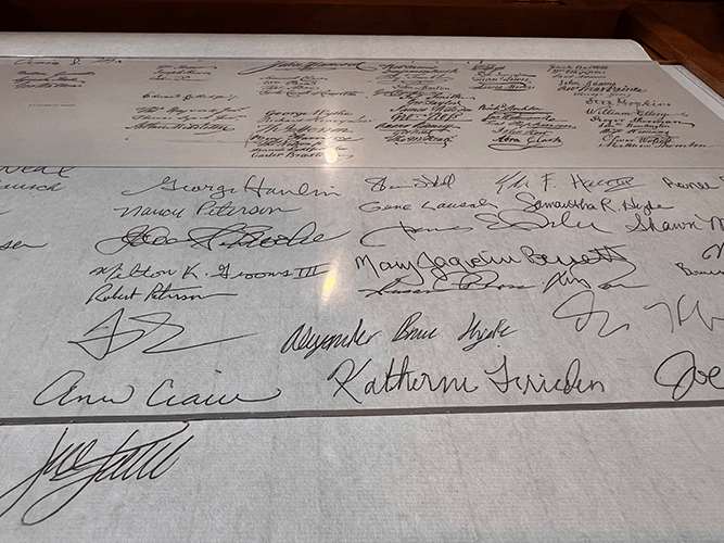 Visitor signatures fill the interactive Declaration scroll
