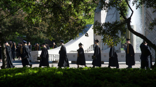 Purdue Students at Commencement Walking in Cap and Gown