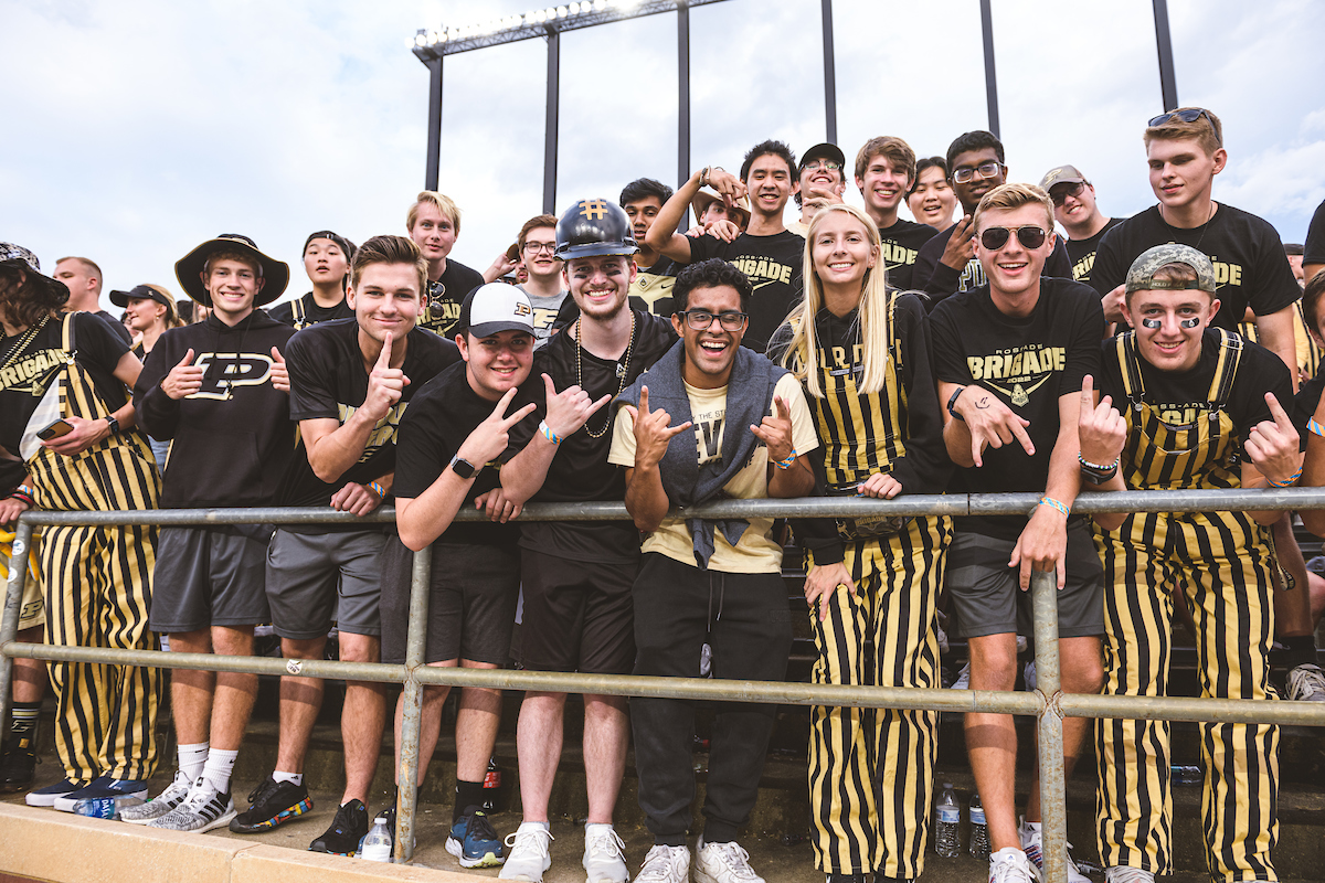 Students in Purdue gear, Purdue overalls, gathering together as a group