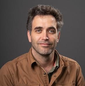 Dr. Bataille smiles at the camera for a headshot photo.