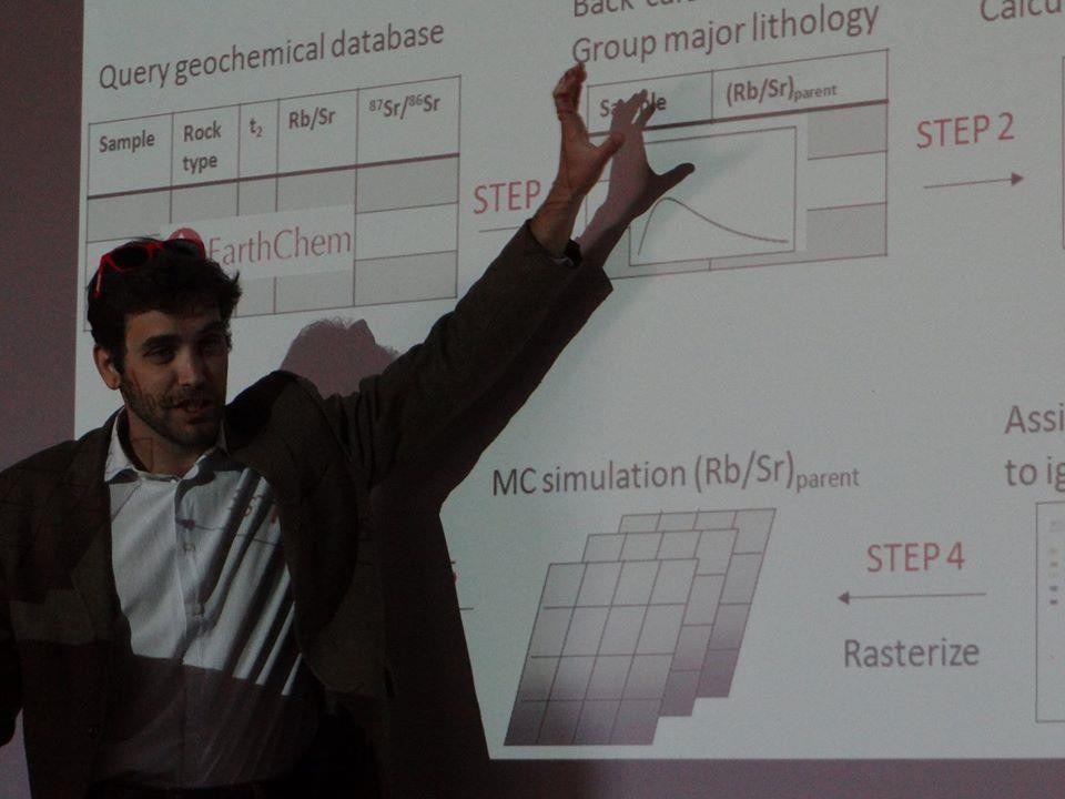 Dr. Bataille stands in front of a projector screen, teaching during lecture.