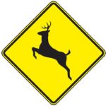 Deer crossing road sign.