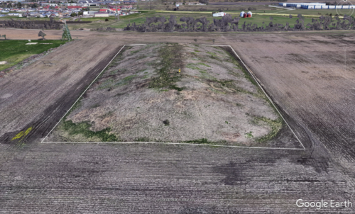 Mound created from soil leftover after diggin a nearby retention pond. Jarred Brooke, FNR extension specialist, frost seeding native grasses and forbs with drone.