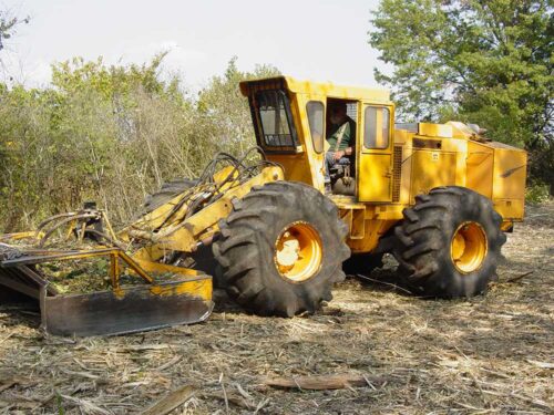 image of tractor cutting forest