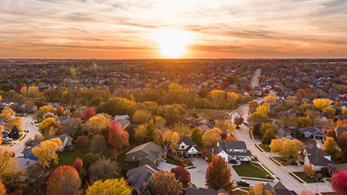 Aerial view of Indiana rural town with sunset in the background.