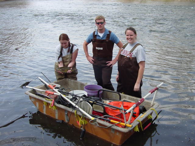 Team members in the water around a supply boat