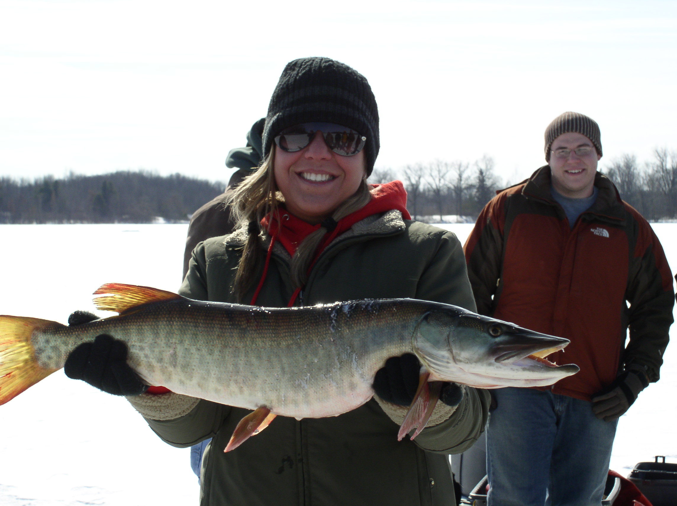 Team members holding a fish