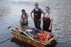 Team members in the water around a supply boat