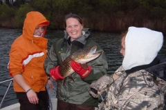 Team members holding a fish