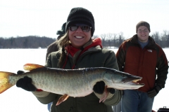 Team members holding a fish