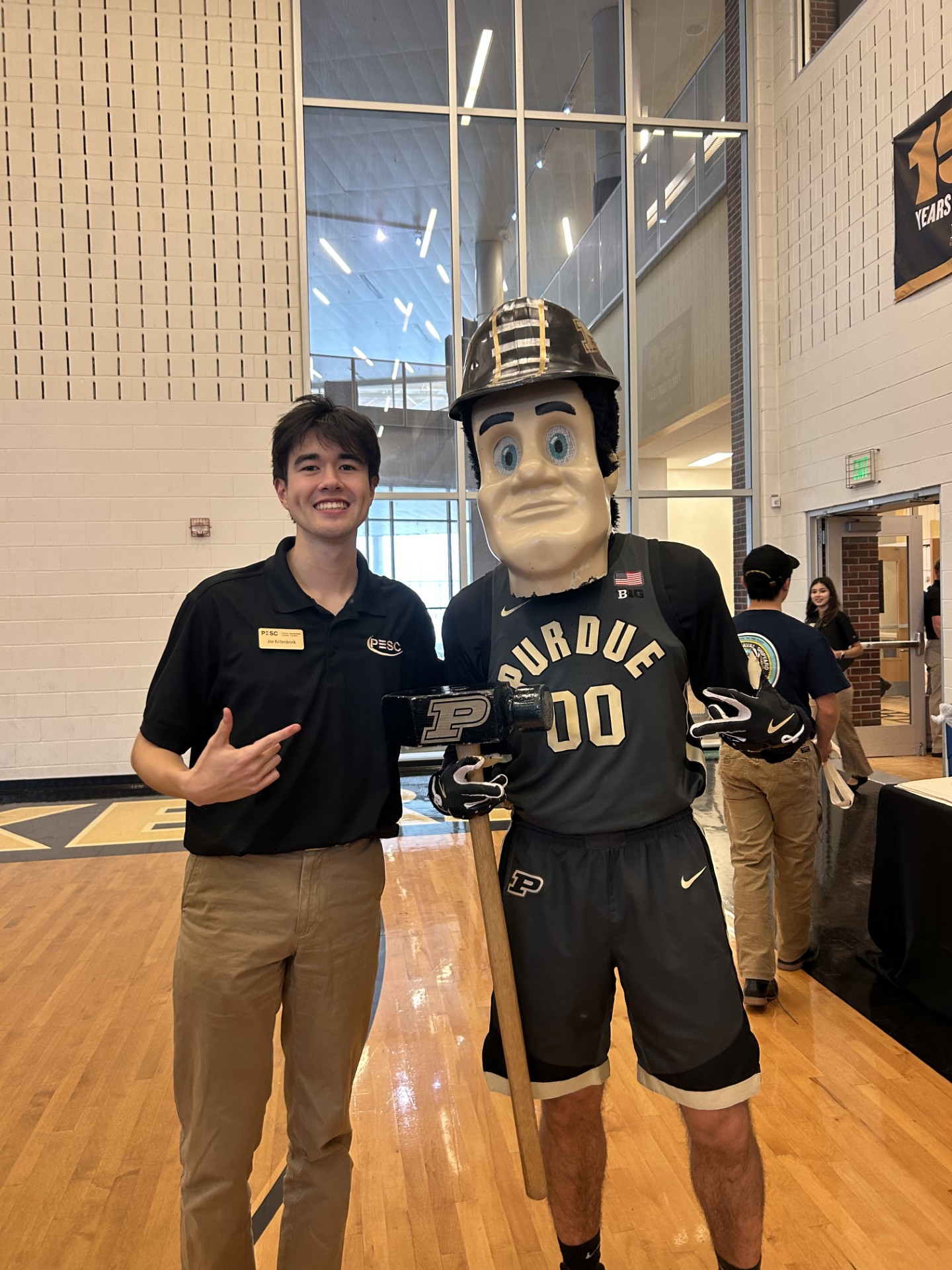 Purdue student standing with Purdue Pete