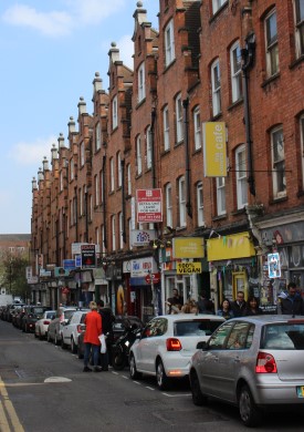 Row houses and vehicles along London's Brick Lane
