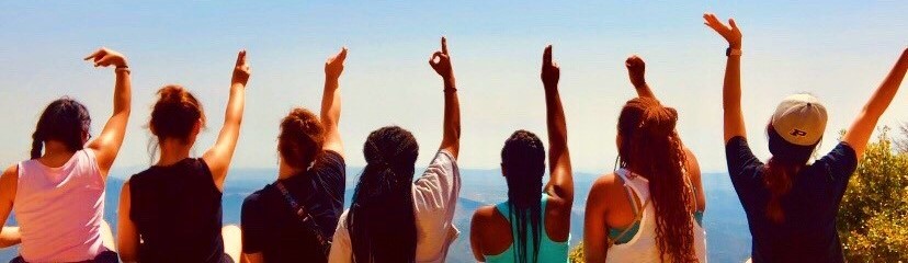 Students displaying welcome with hand gestures.