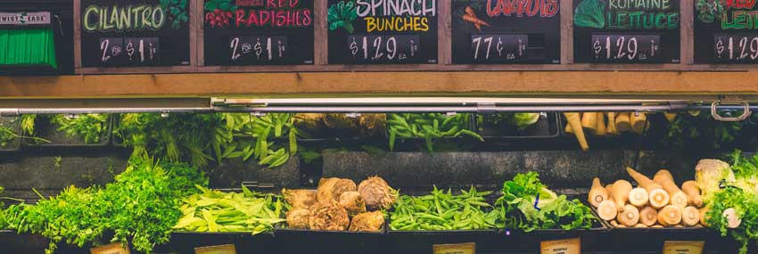 Various produce items in bins at a grocery store