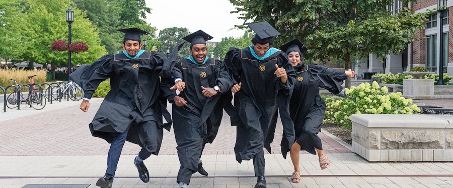Graduating students jumping and celebrating