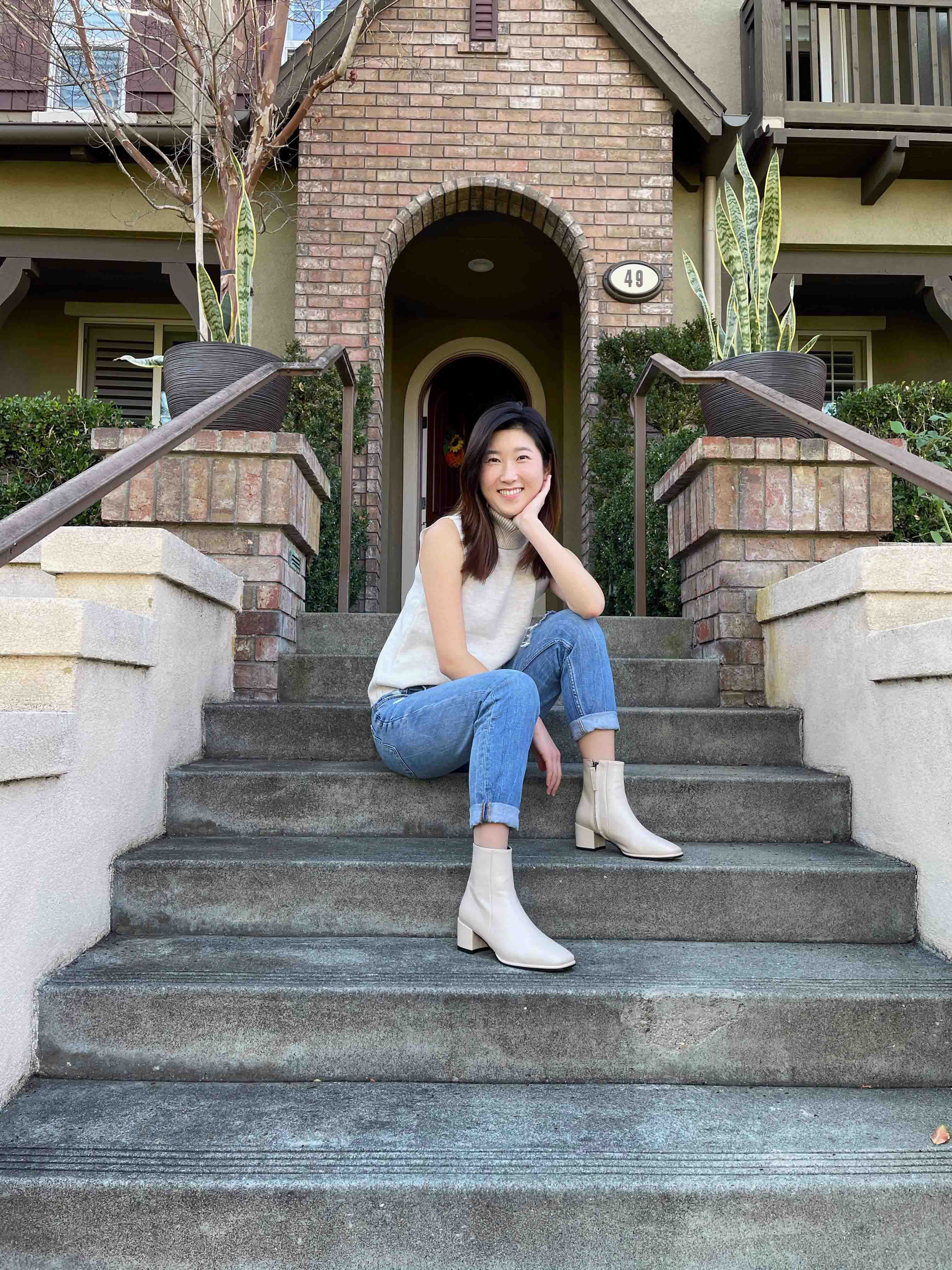 Jenny Woo sitting on the steps of a building at Purdue