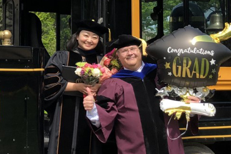 Wan Hee Kim with advisor at commencement.