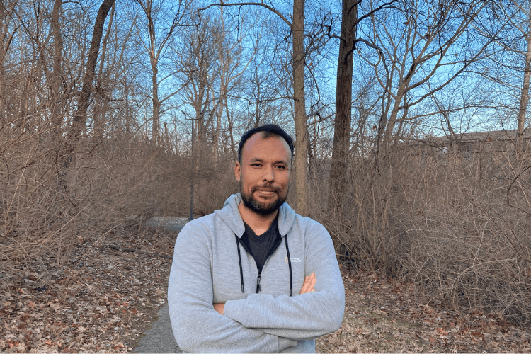 Purdue graduate student, Vahidullah Tac, posing in woods.