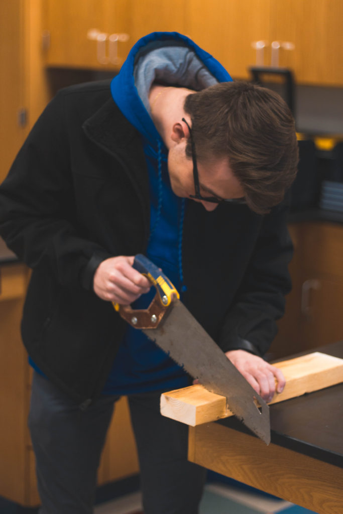 Student using a saw