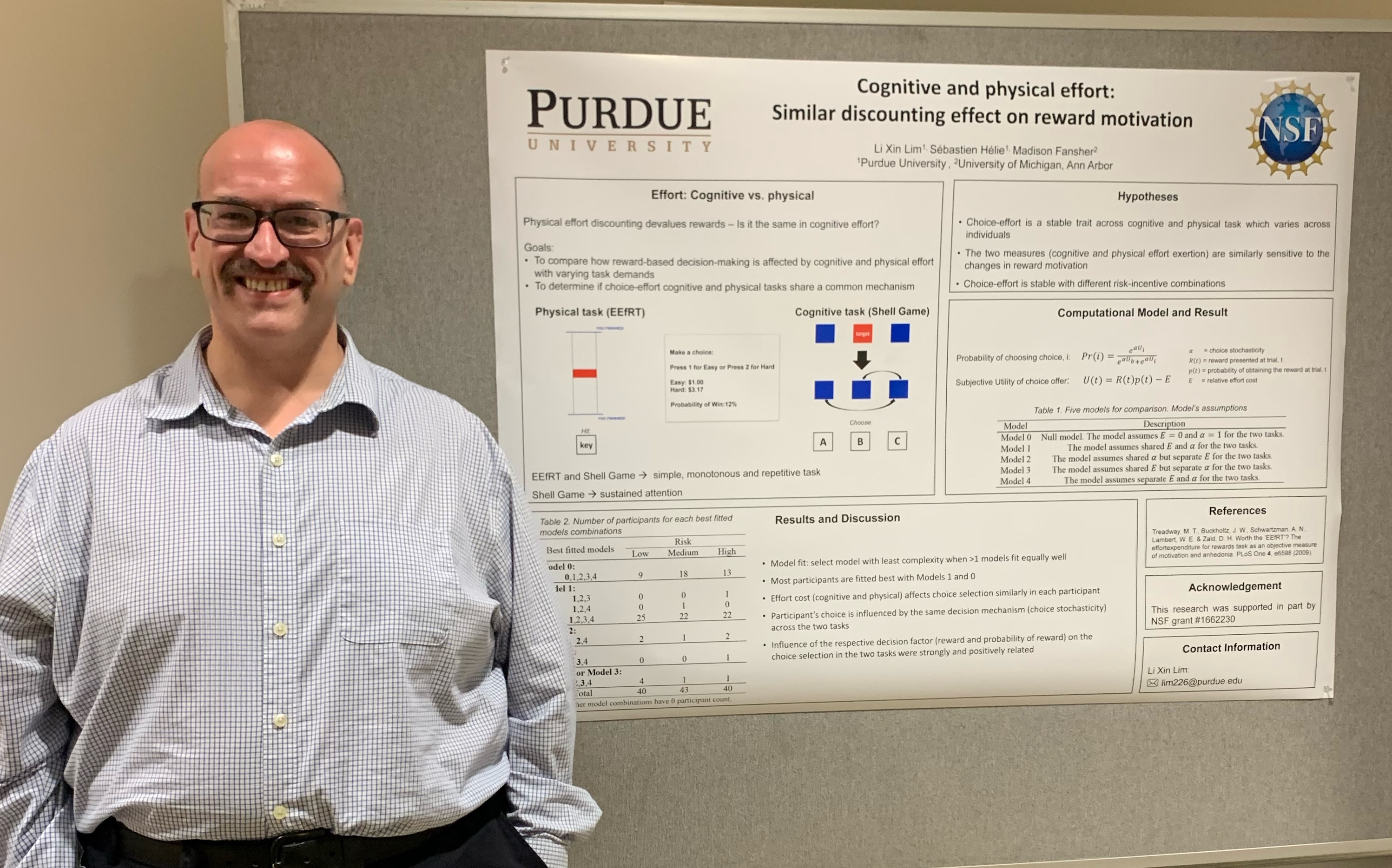 Photo of Dr. Sebastien Helie with the poster that Li Xin Lim presented.