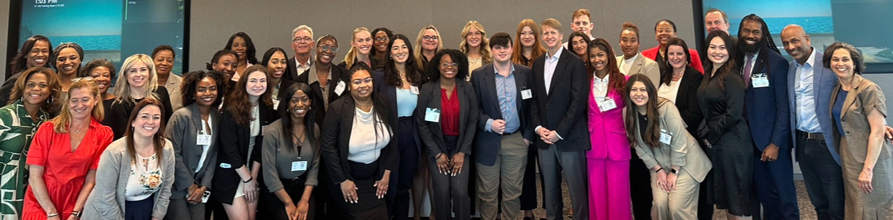 Two millennial women female friends sitting outdoors eating takeaway food, laughing and having fun. Food delivery and takeout.