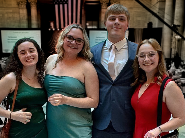 Two millennial women female friends sitting outdoors eating takeaway food, laughing and having fun. Food delivery and takeout.