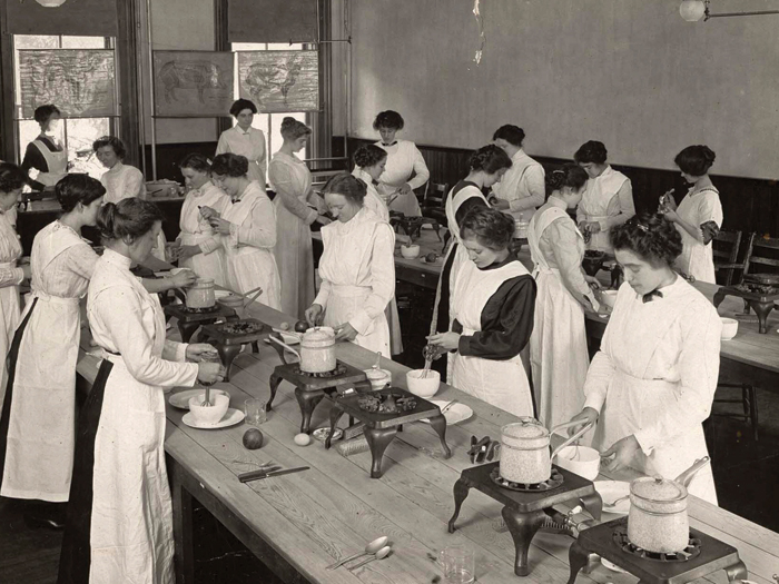 Students cook in an early food laboratory class in the School of Home Economics