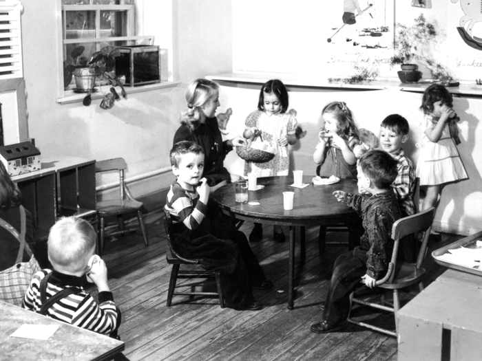Children in a Purdue nursery school enjoy some mid-morning snacks in the 1940s