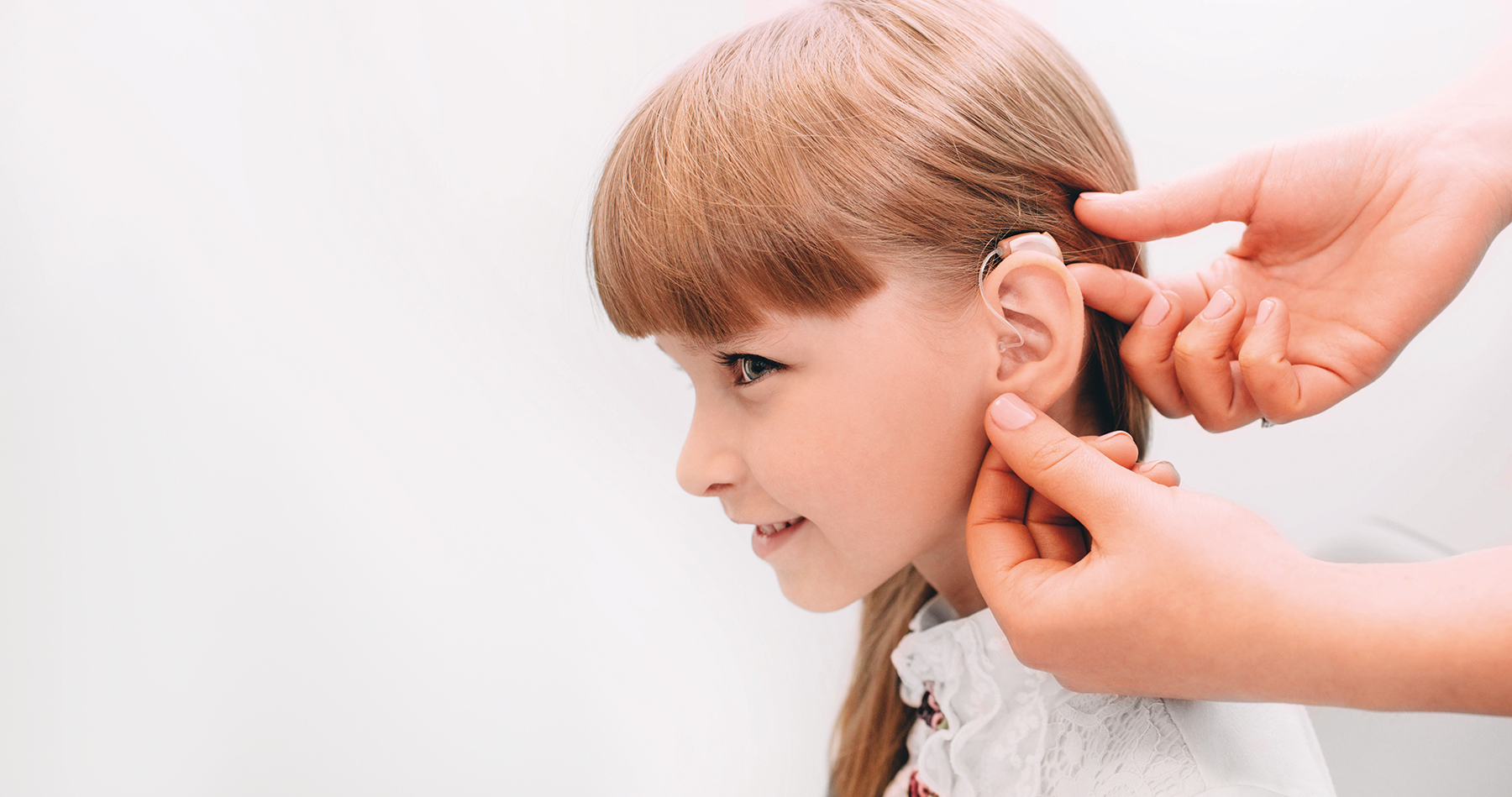 Little girl with hearing device
