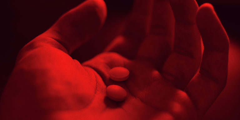 Responding to the opioid crisis - person holding 2 pills