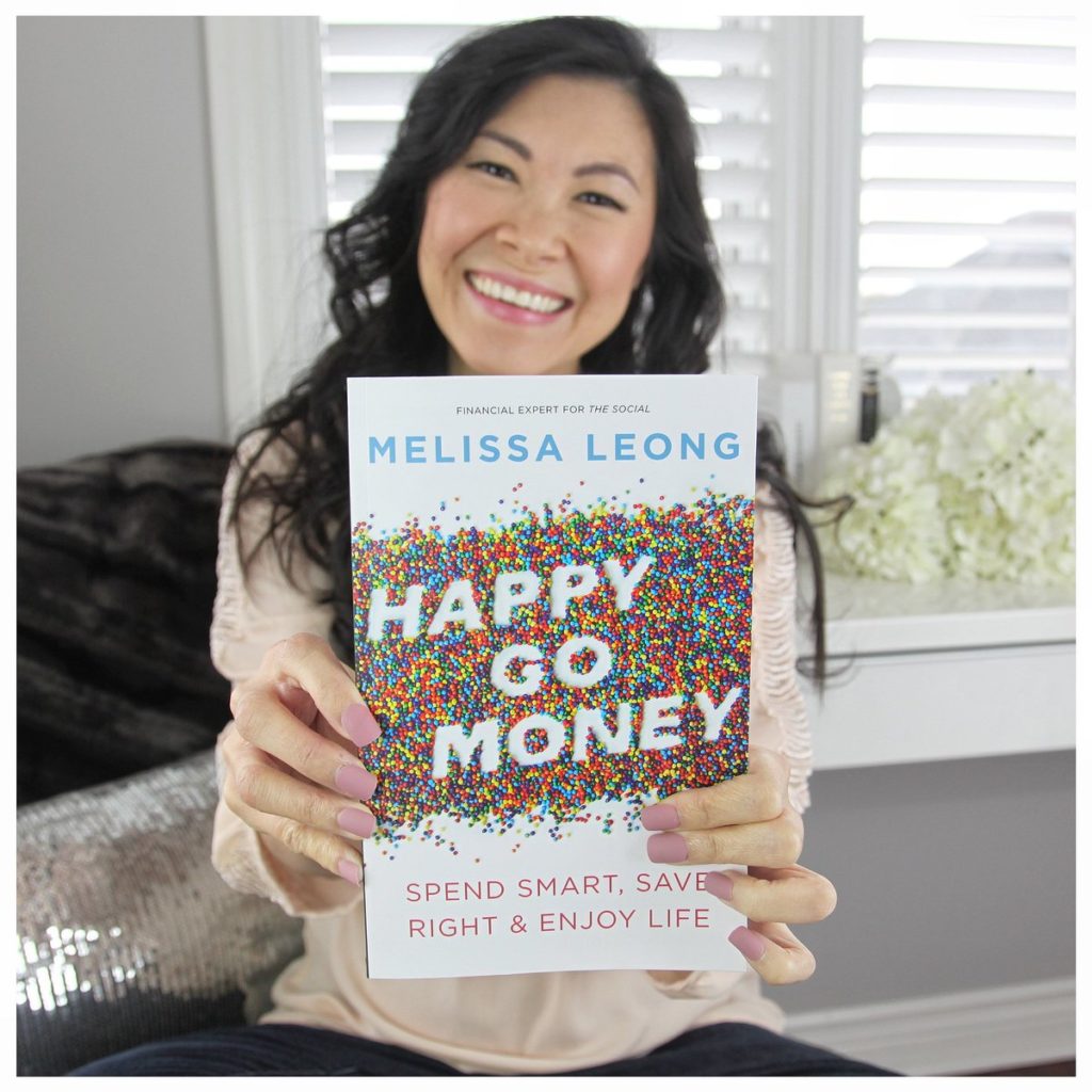 Melissa Leong holding a copy of Happy Go Money