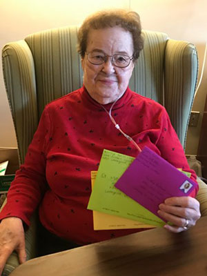 A resident of St. Mary Healthcare Center with her letters.
