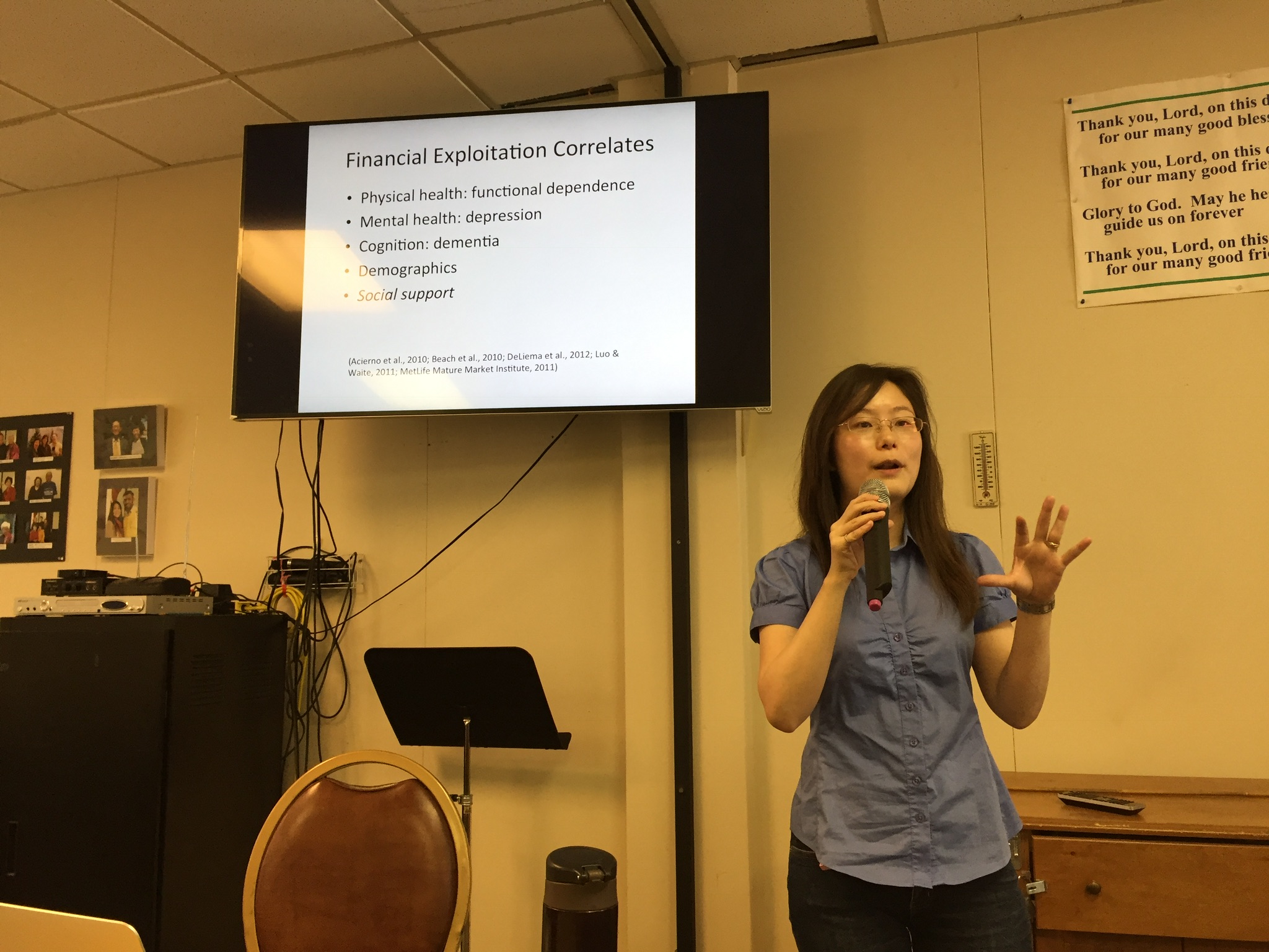 Liu gives a community talk on elder financial abuse to a group of older adults in a church.