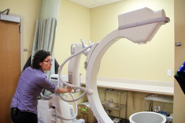 Georgia Malandraki adjusts an x-ray machine