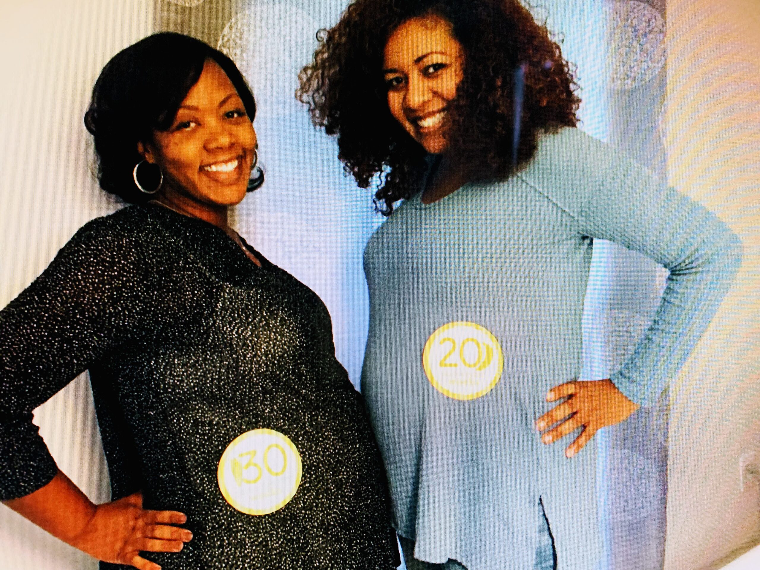Shalon Irving and Bianca Pryor pose for a photo showing how far along they are in their pregnancies.