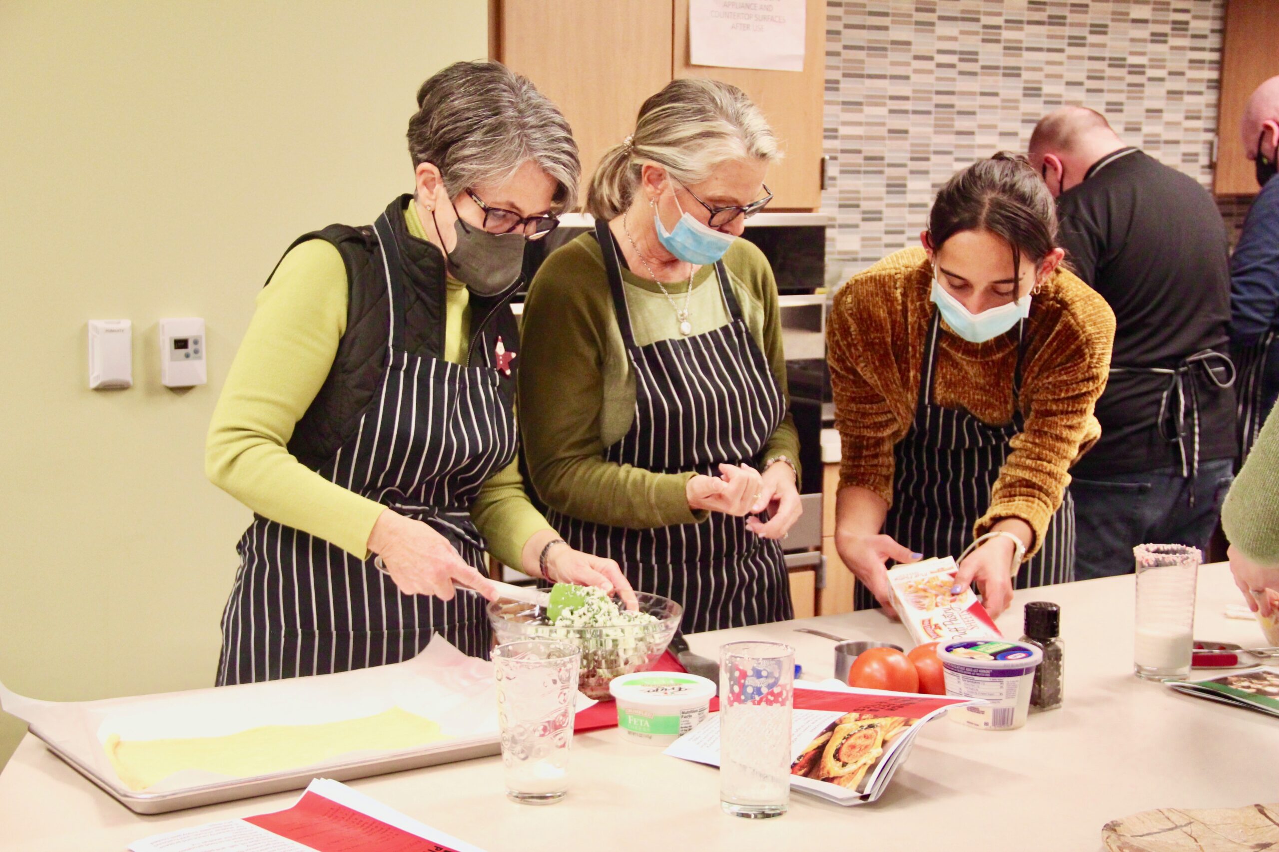 Aguie Fainguersch, right, helps participants during a cooking demonstration