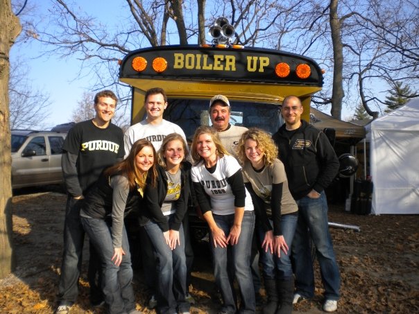 Hall poses with her family in front of "Boiler Up" bus