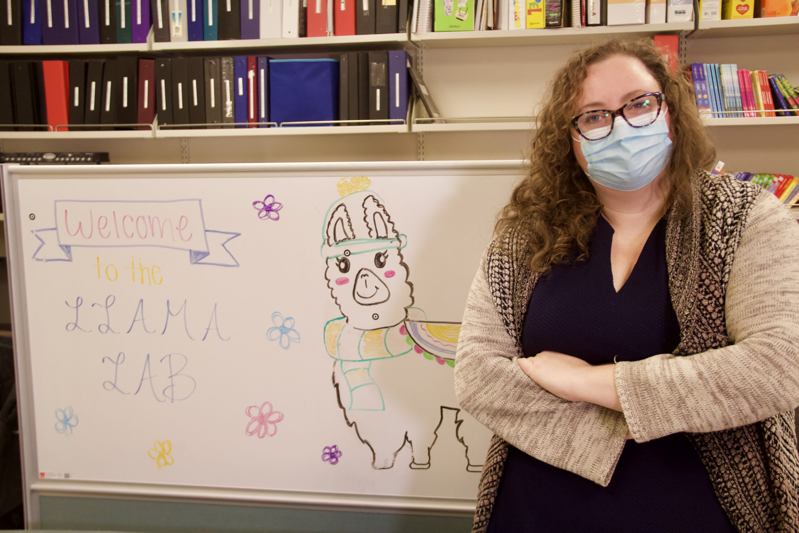 Arielle Borovsky stands in front of a LLAMA Lab sign