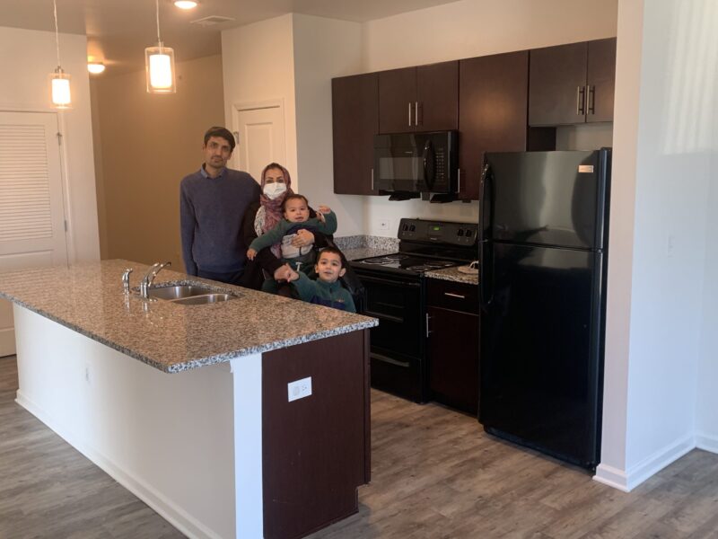 Afghani family pose for photo in an Indianapolis apartment