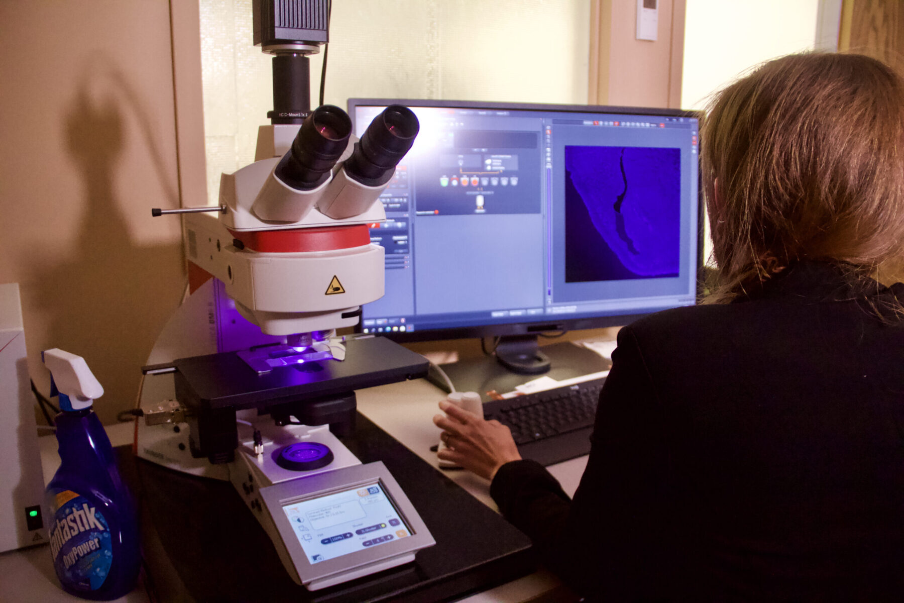 Professor Sydney Trask uses her trusty Leica fluorescence microscope.
