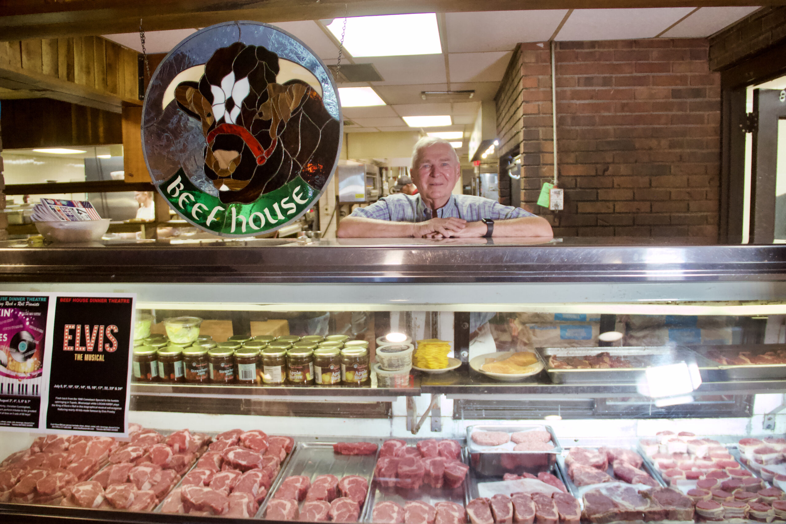 Robert Wright stands behind his restaurant's meat case.
