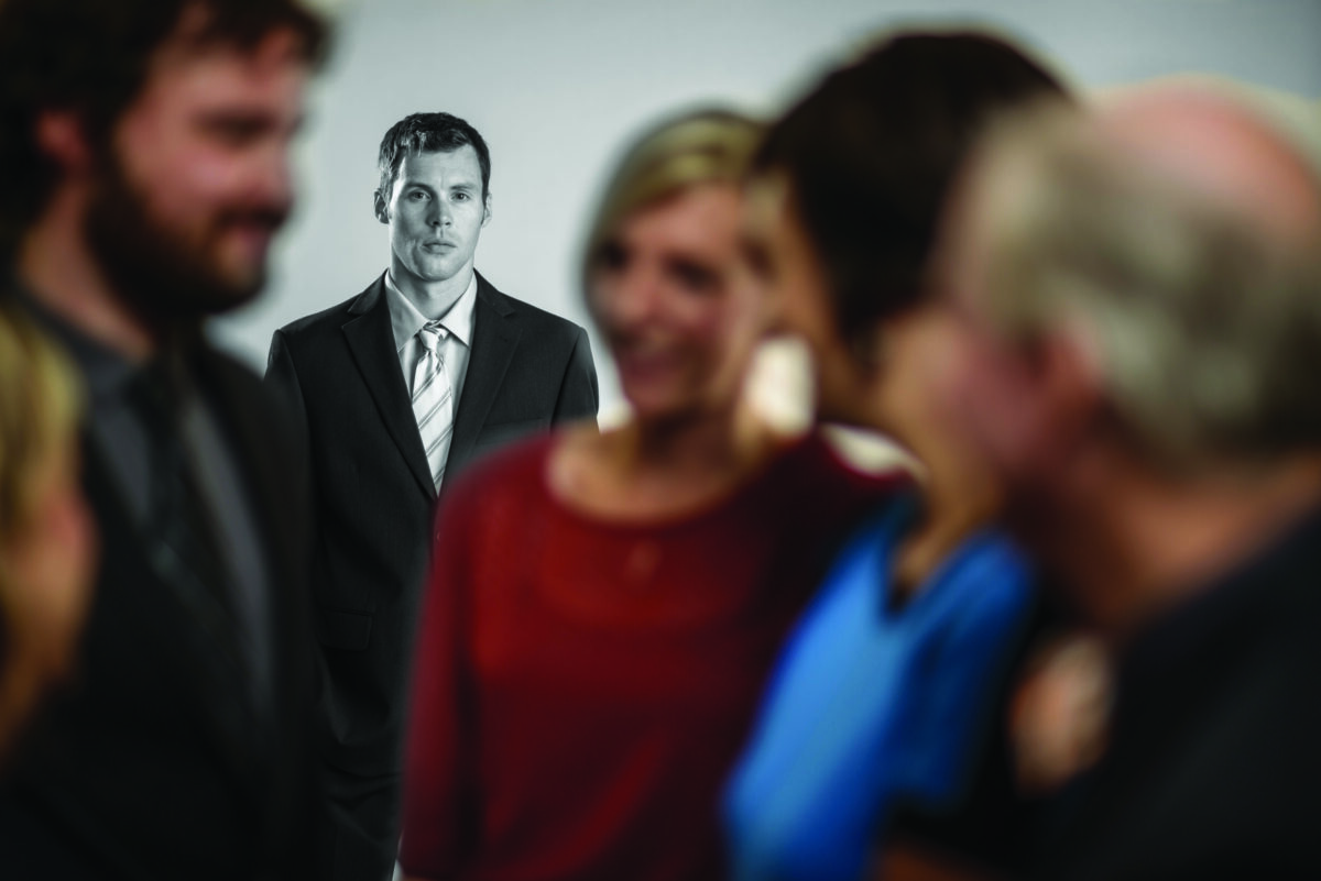 Man stands isolated from crowd