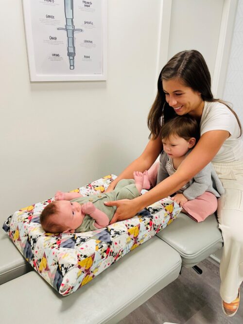 Liron Saletsky performs a chiropractic adjustment on a baby