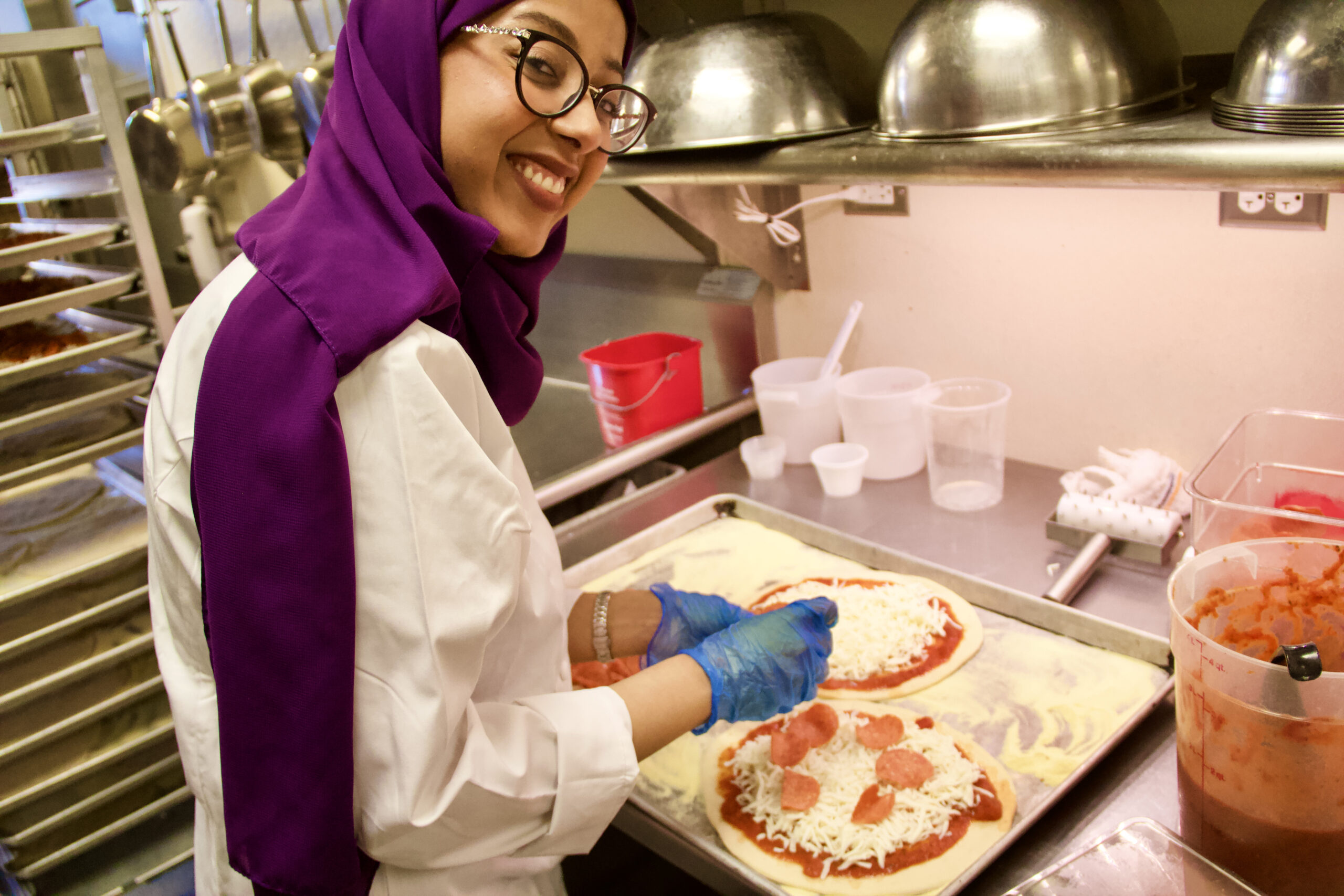 Shooq Alsuwailem prepares pizzas in the John Purdue Room.