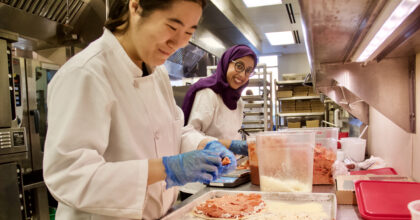 Students make pizzas in the John Purdue Room kitchen.