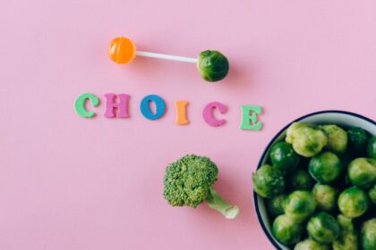 A photo illustration of candy and vegetables and the word "choice"