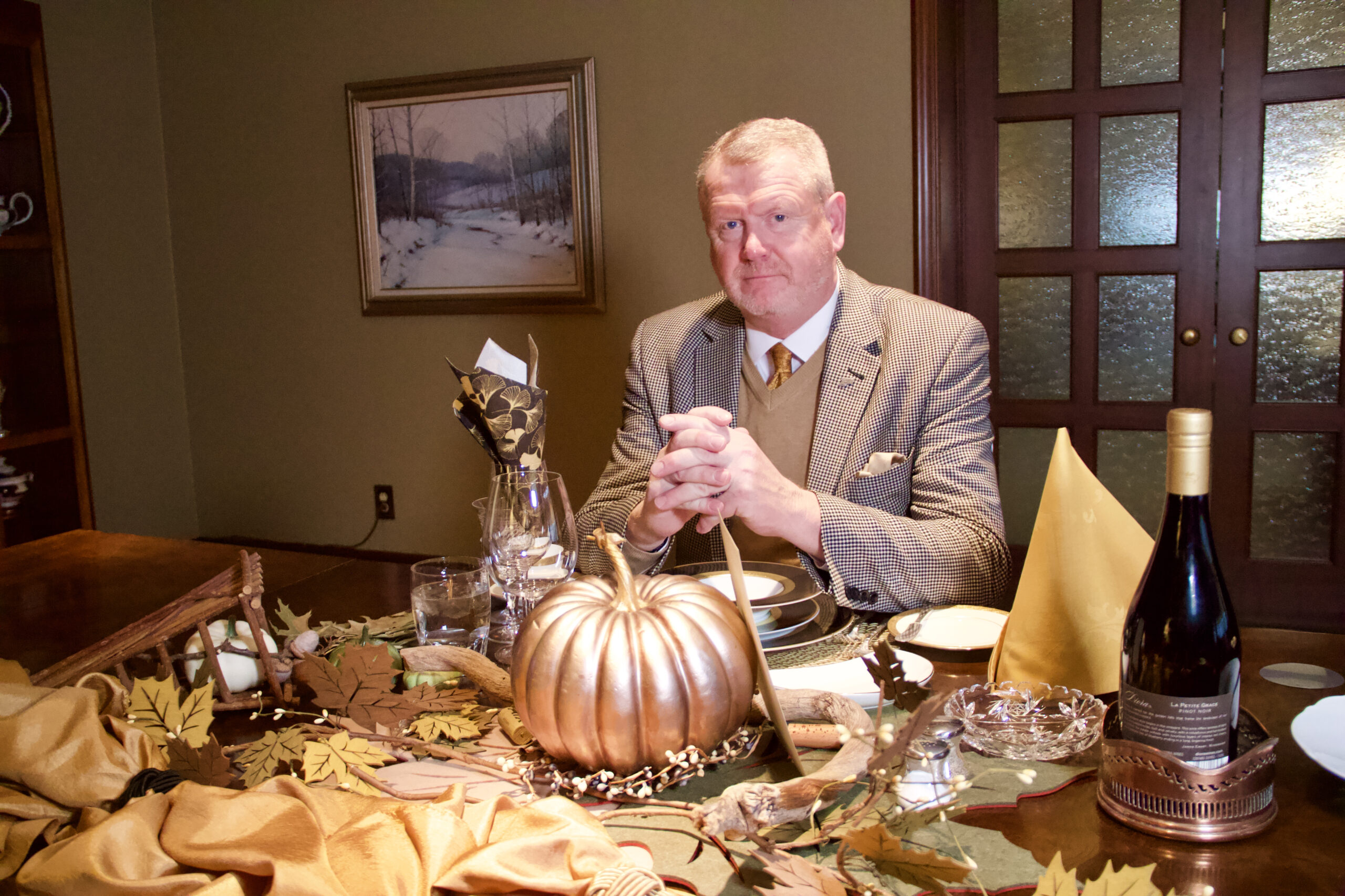 Anthony Cawdron sits at a festive table in Westwood.