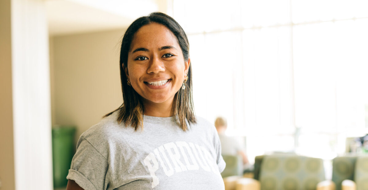 Yumi Mayes poses for a photo in Lyles-Porter Hall