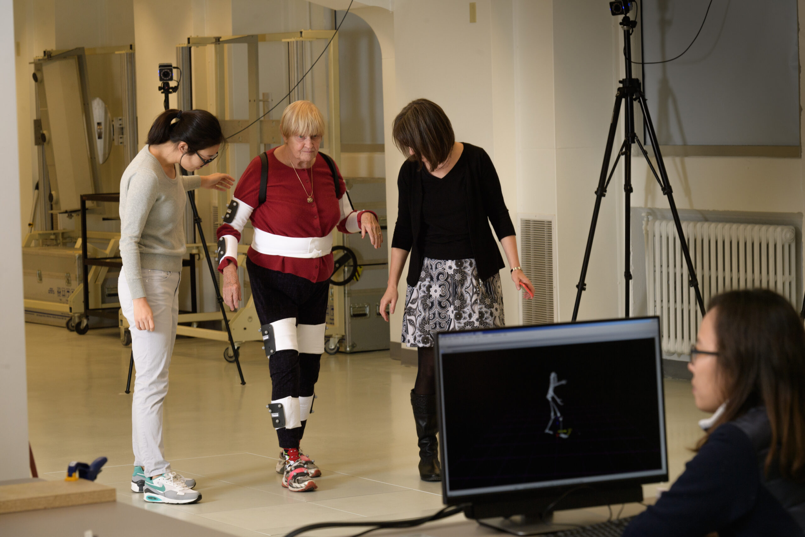 A research participant walks with the help of Purdue health and kinesiology researchers.